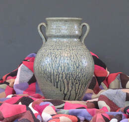 Clay vase on colorful backdrop by Sandra Barker